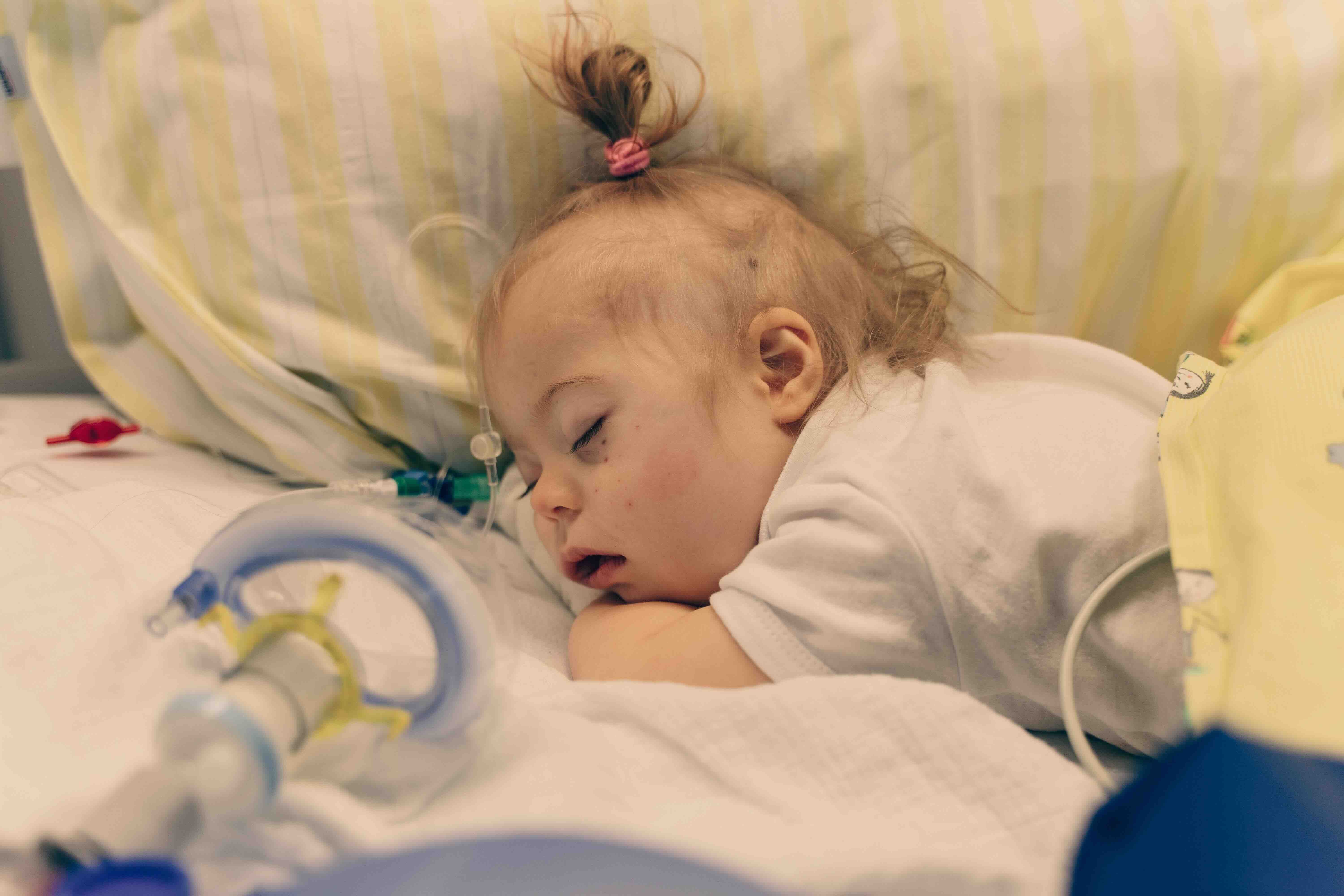 hand of an adult holds hand of a baby